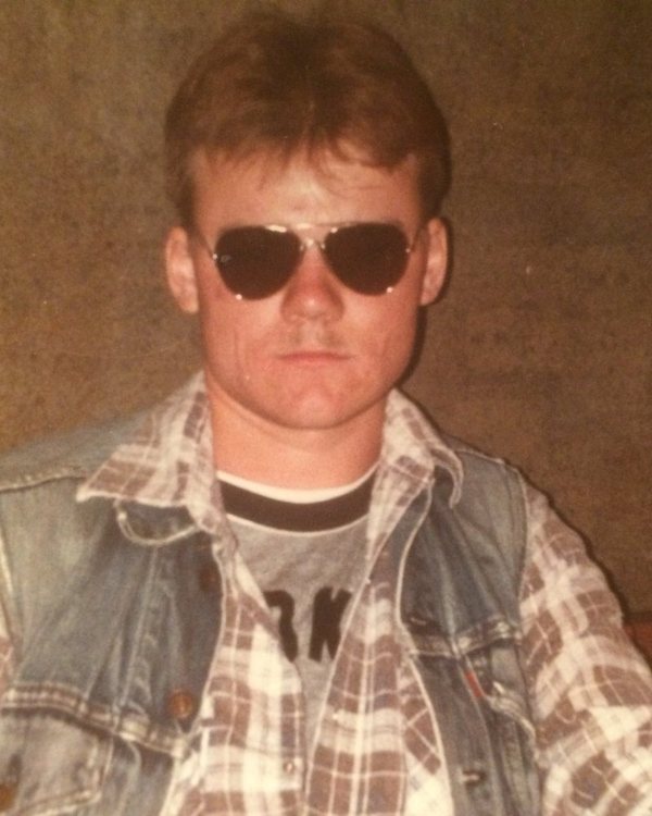 Will Power as a young man in Brooklyn, in aviator sunglasses and a denim vest